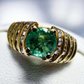 14K yellow gold ring with central VS grade emerald and diamond-studded wide band