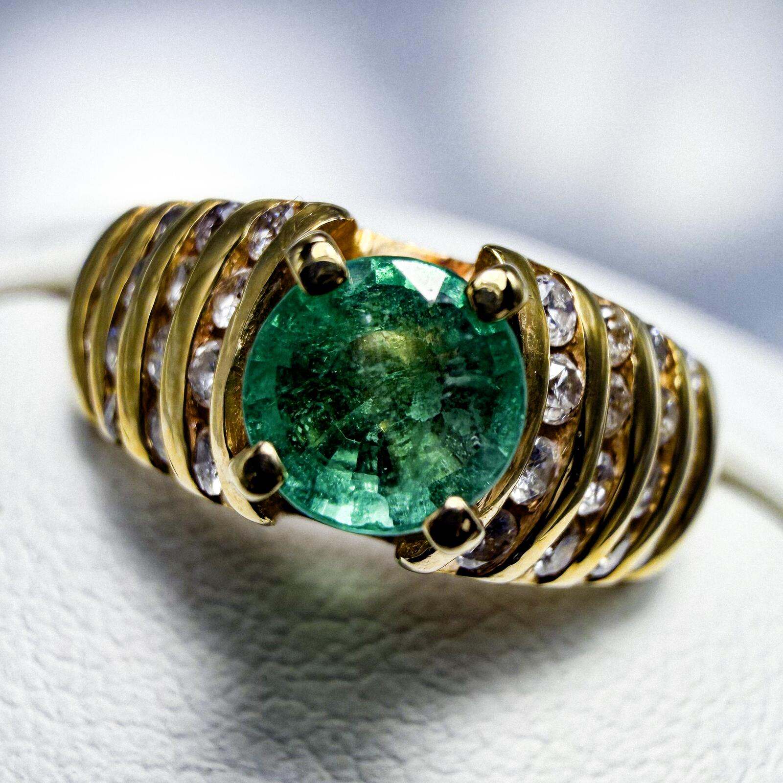 14K yellow gold ring with central VS grade emerald and diamond-studded wide band