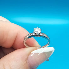 14k white gold engagement ring set with 1 round  (0.51ct) diamond and 10 diamonds surround it.