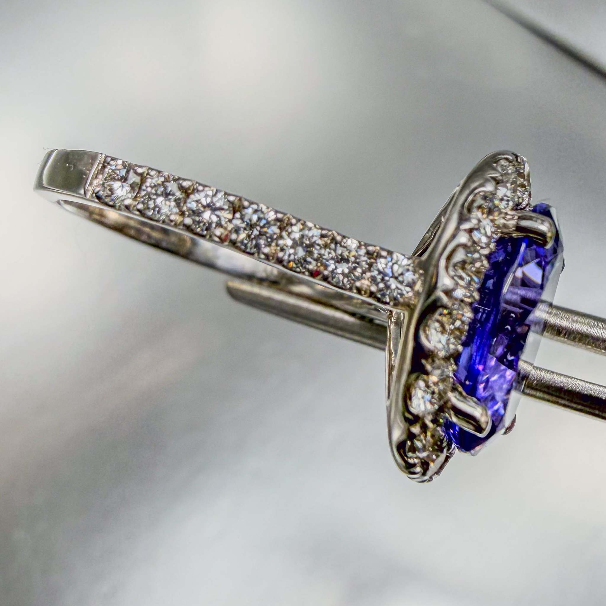 Close up side-view of a pavé diamond white gold ring with bright polish finish | by Custom Jewellers by Gianni