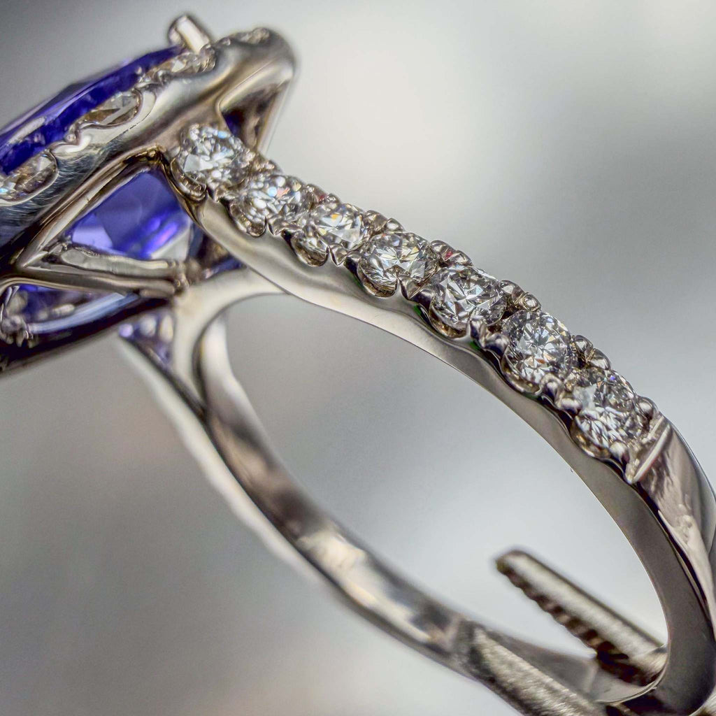 Close up side-view of a pavé diamond white gold ring with bright polish finish | by Custom Jewellers by Gianni