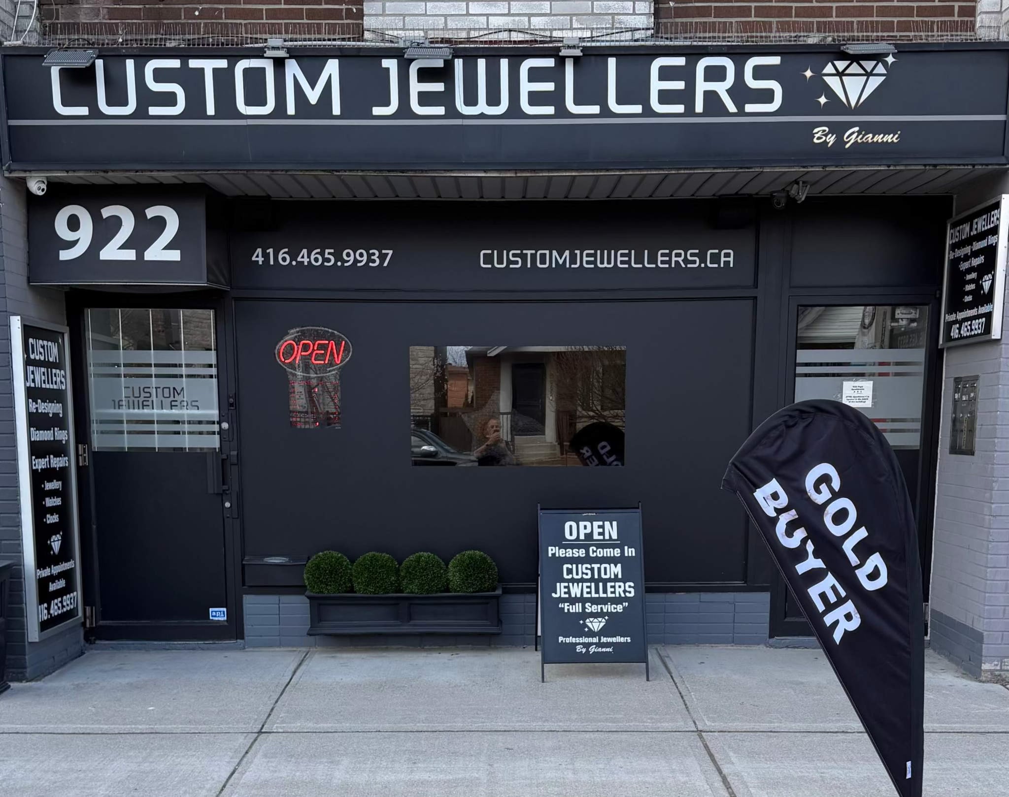 Custom Jewellers storefront with contact information and promotional sign.