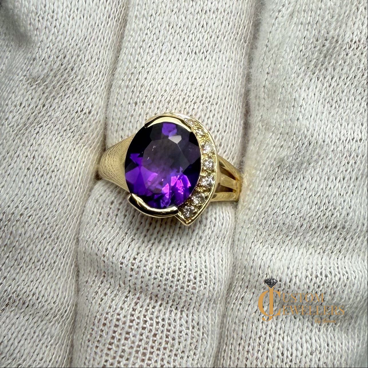 A yellow gold ring featuring a large oval-cut purple amethyst centre stone, accented by small diamonds set along a half-halo edge.