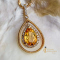 Swinging teardrop honey yellow citrine pendant necklace with diamond halo in 10kt yellow gold