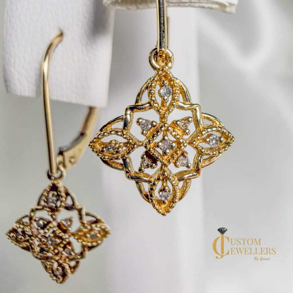 Vintage-style geometric gold and diamond drop earrings with delicate filigree and milgrain detailing