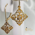 Vintage-style geometric gold and diamond drop earrings with delicate filigree and milgrain detailing