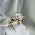 Hand assembled custom VVS2 diamond ring in 14k yellow gold with lab-grown oval bezel diamond and eight shoulder diamonds