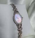 Extremely RARE Vintage ladies’ watch in silver-tone metal, with an iridescent mother-of-pearl oval dial and ornate linked bracelet.