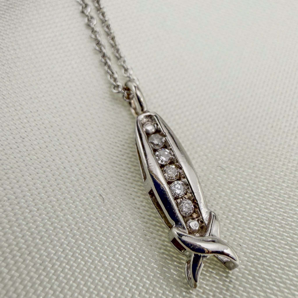 Diamond Channel 10k White Gold pendant necklace with a slim channel of round diamonds and a sculpted, crossed-end design.
