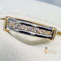 Yellow and white gold ring on a white cushion with 'Custom Jewellers' branding.