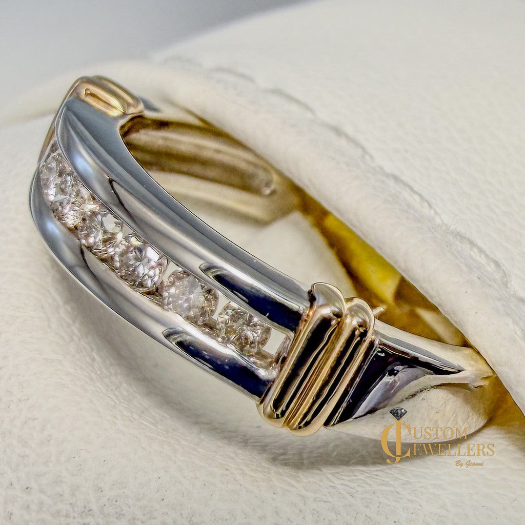 Yellow and white gold ring on a white cushion with 'Custom Jewellers' branding.