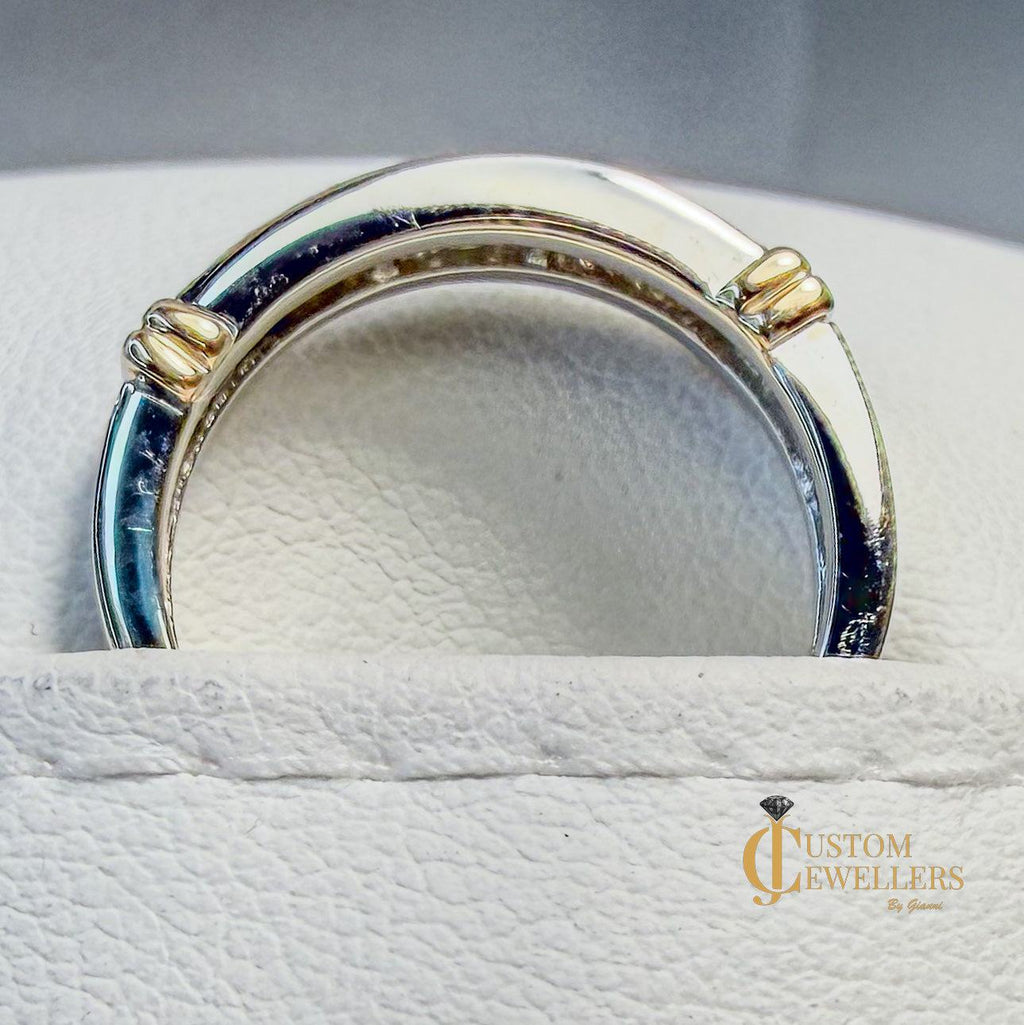 Yellow and white gold ring on a white cushion with 'Custom Jewellers' branding.