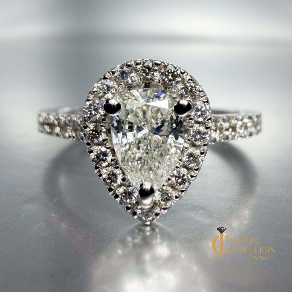 Designer halo engagement ring with pear diamond in 14k white gold and pave diamond band