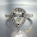 Designer halo engagement ring with pear diamond in 14k white gold and pave diamond band