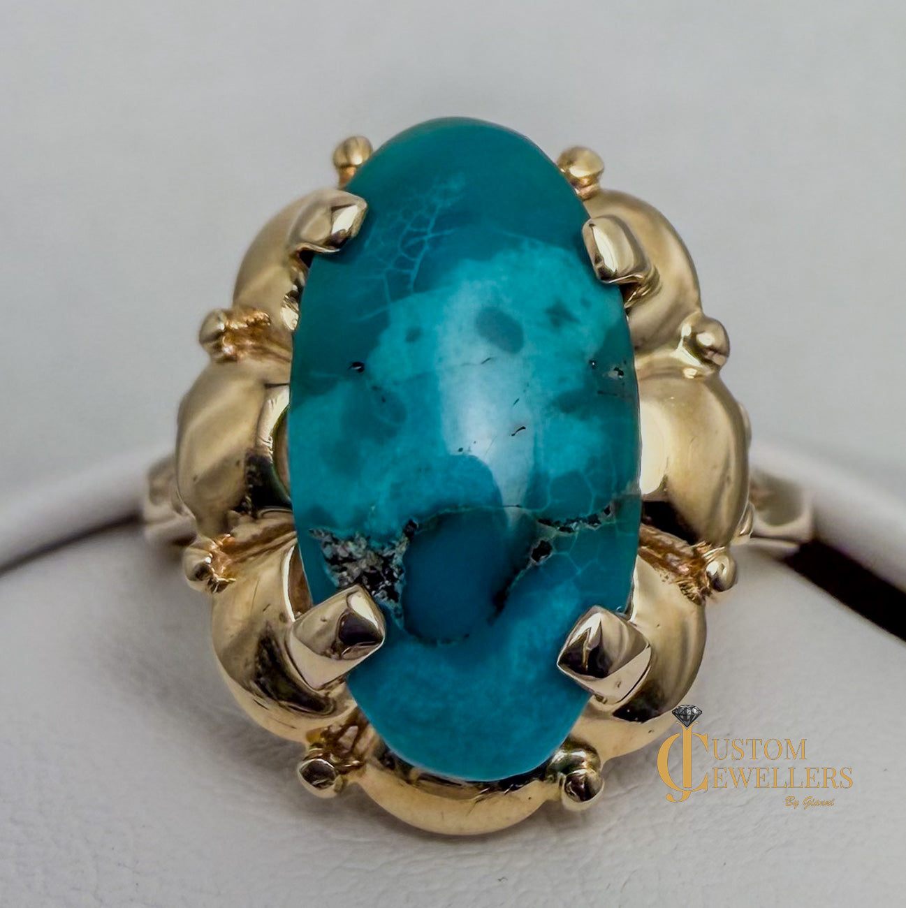 Stunning turquoise stone set in polished 14k yellow gold statement ring