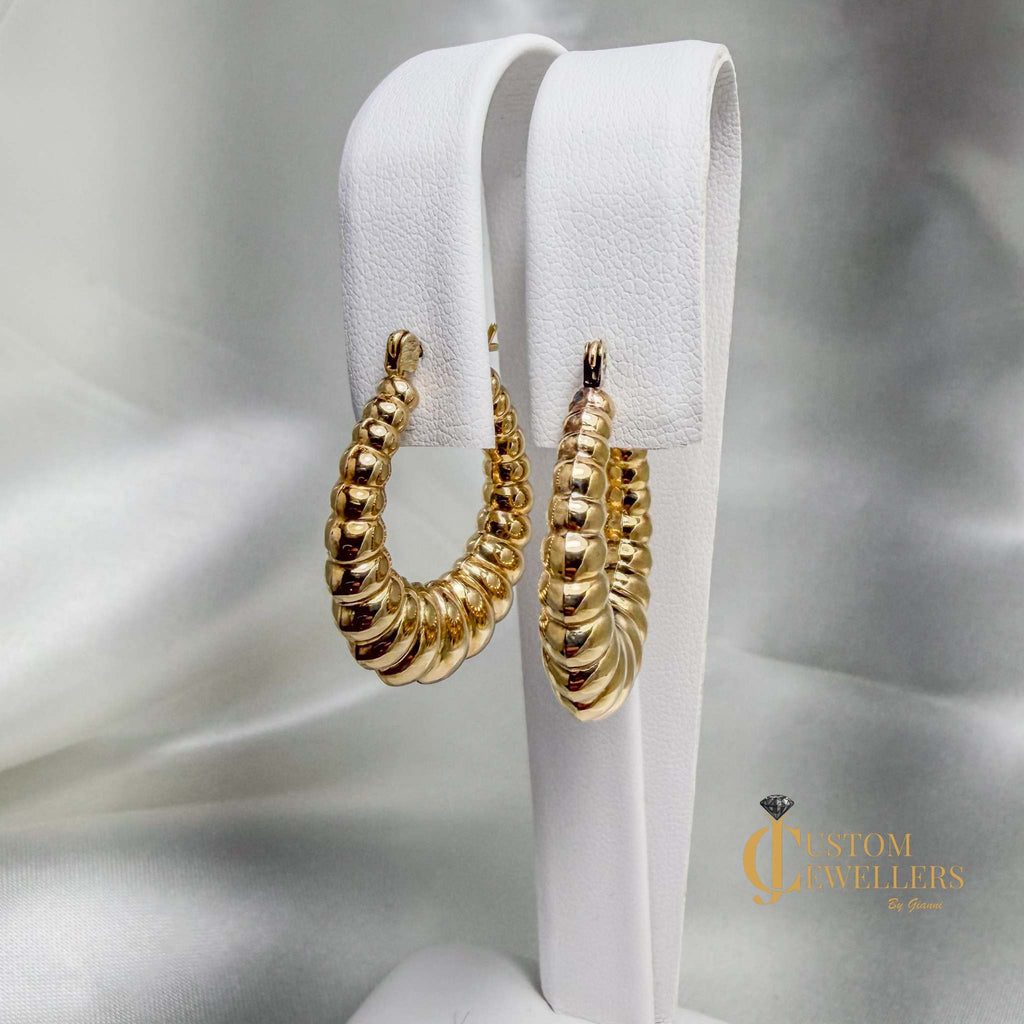 Seashell-inspired 14kt yellow gold hollow oval hoop earrings with graduated ripples
