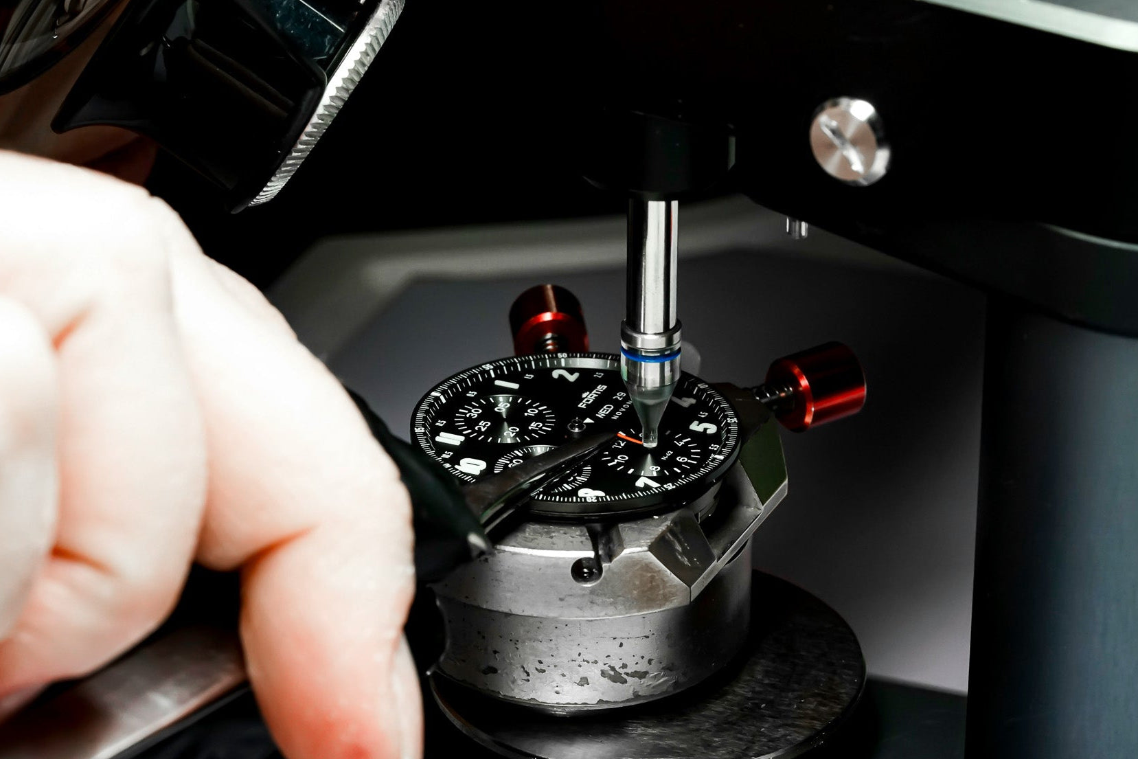 Close-up of a watch being adjusted by a watch maker