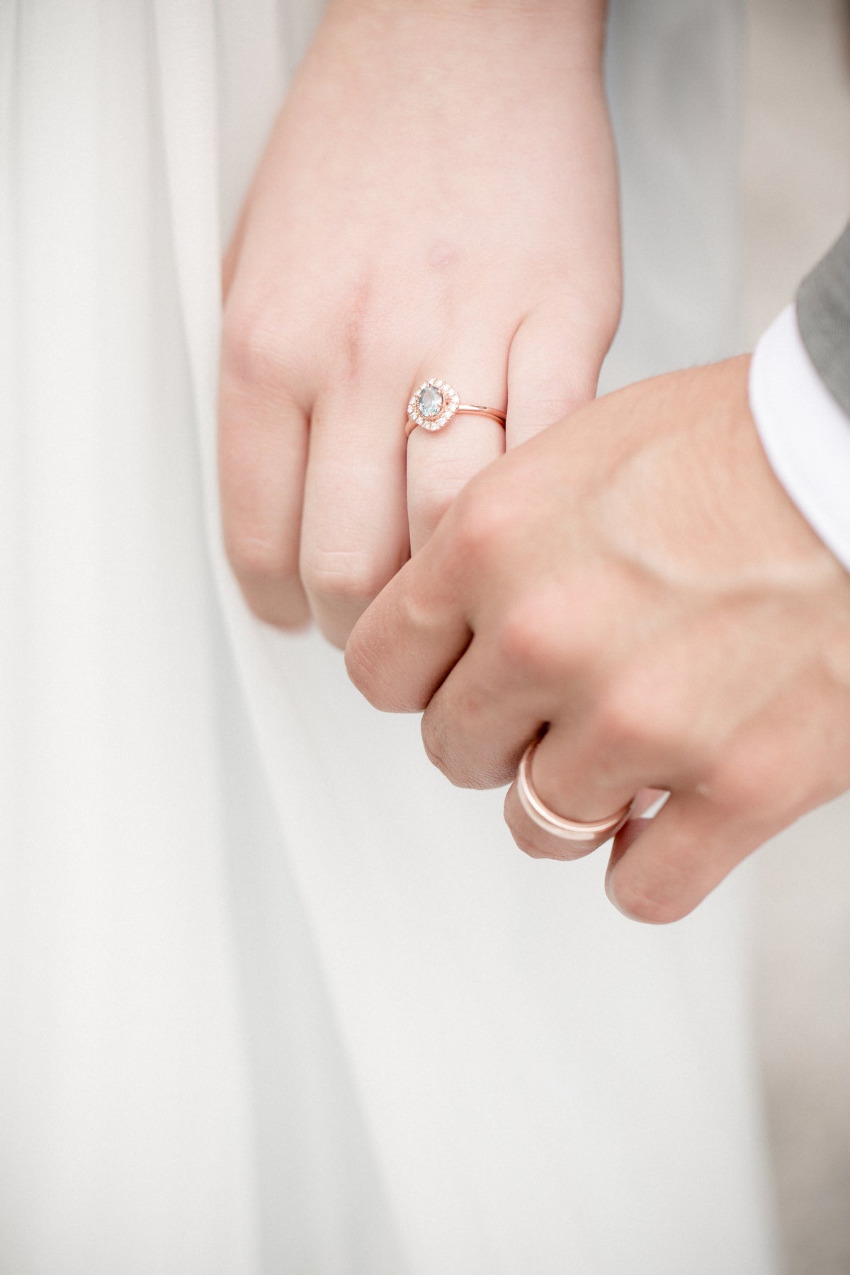 Two hands wearing wedding bands