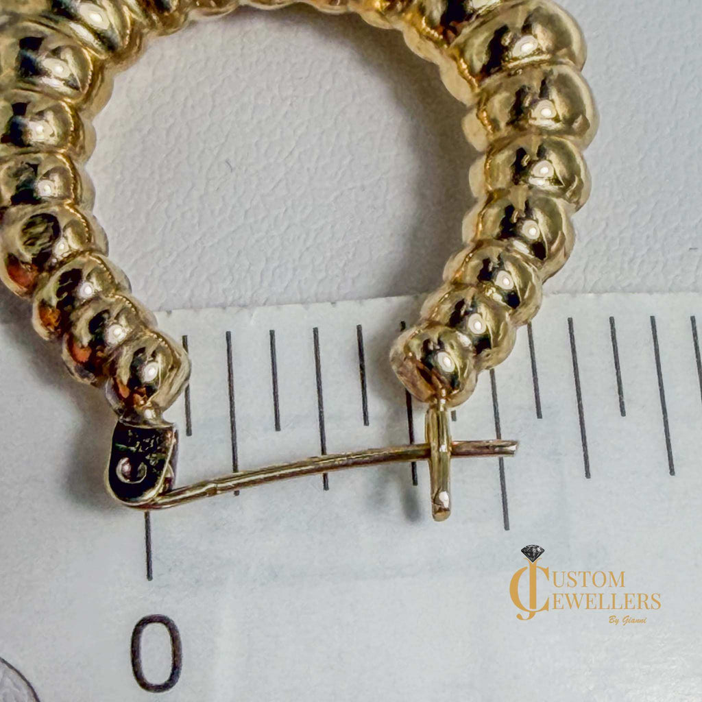 14kt gold seashell-inspired hollow oval hoop earrings with rippled design