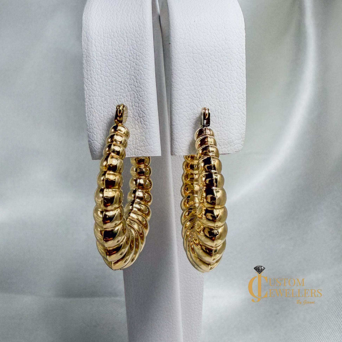 14kt yellow gold seashell-inspired oval hoop earrings with ripple design