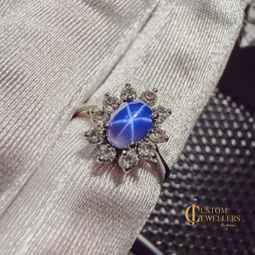 Star sapphire ring in 10k white gold with diamond halo