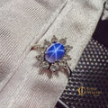 Star sapphire ring in 10k white gold with diamond halo